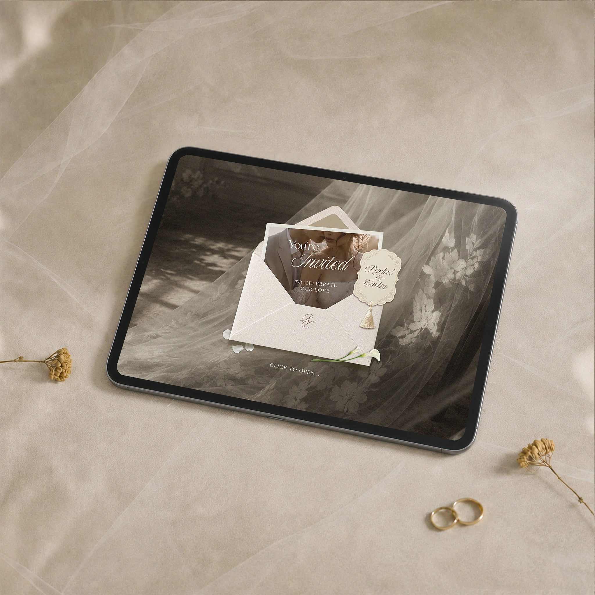 Heirloom Romance wedding website template shown on iPad, cream envelope with tassel charm over sepia bridal veil