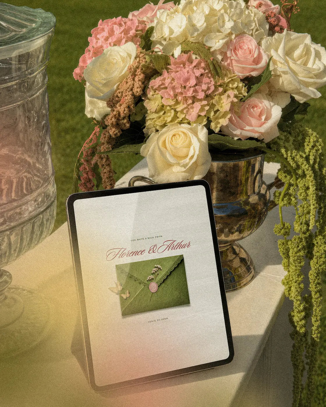 Semi custom wedding website design preview on tablet with floral arrangement, romantic garden aesthetic