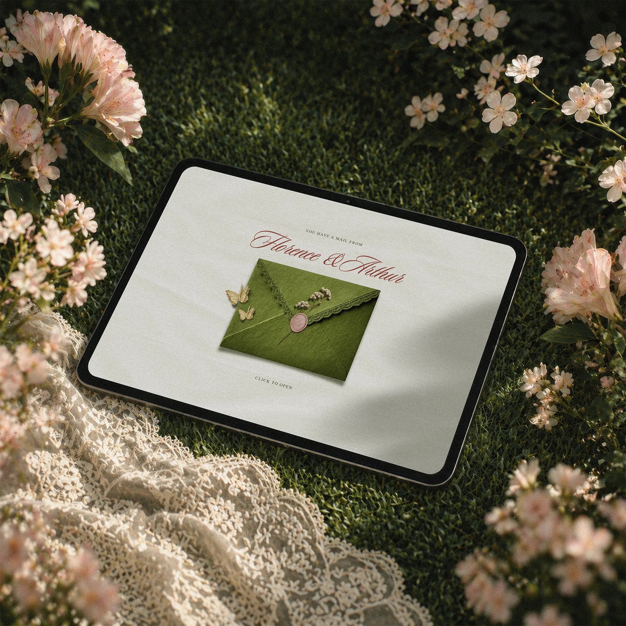 Timeless Garden wedding website template shown on iPad, sage green envelope reveal design surrounded by pink flowers